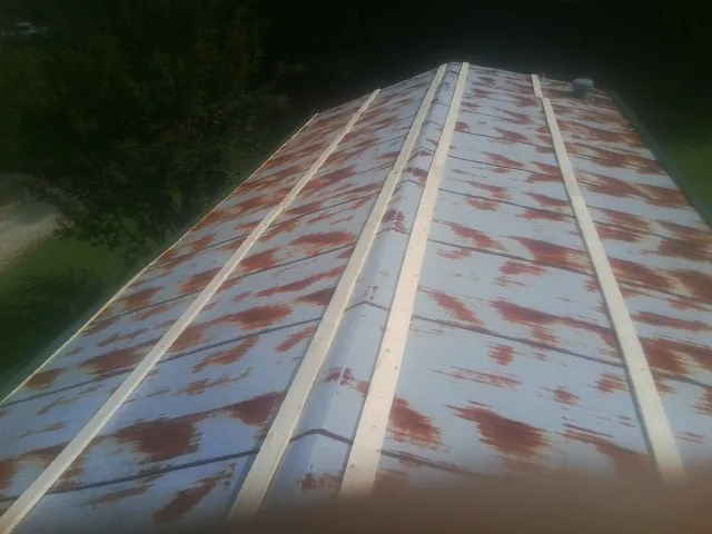 Rusted metal roof panels with new wood purlins before replacement — Storm Damage Roof Repair in Havre De Grace by Roofing Brothers